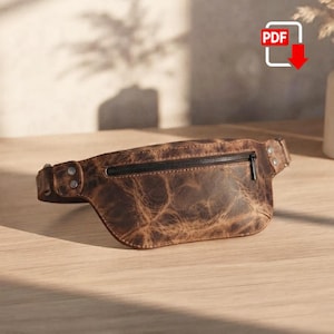 May include: A brown leather bum bag featuring a distressed, marbled texture with visible grain patterns. The bag includes a horizontal black zippered compartment across the front and is secured at the sides with two silver-toned metal rivets.