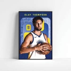 May include: A basketball poster featuring Klay Thompson, a basketball player for the Golden State Warriors. He is wearing his team jersey and holding a basketball. The poster has a blue and yellow background with a city map design.