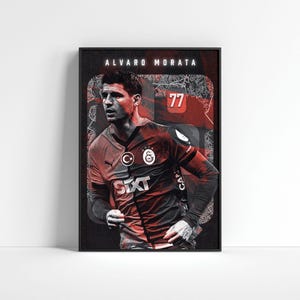 May include: Framed poster featuring a portrait of Álvaro Morata in a Galatasaray jersey. The poster has a black frame and a dark background with the player's name and number 77 displayed prominently. The SIxT logo is visible.