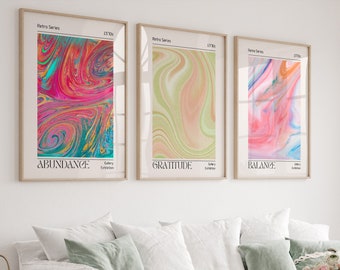 May include: Three framed abstract art prints with swirling patterns in shades of pink, blue, green, and yellow. The prints are titled "Abundance", "Gratitude", and "Balance".