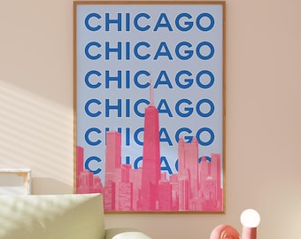 May include: A framed print with a blue background and the word "CHICAGO" repeated five times in a bold blue font. The print features a pink silhouette of the Chicago skyline with the Willis Tower as the tallest building.
