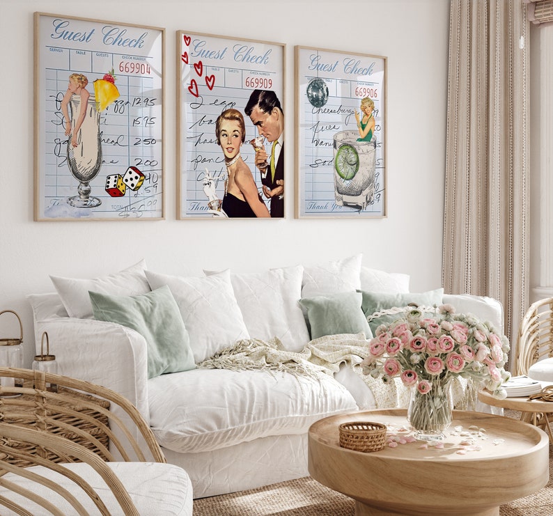 May include: Three vintage-style prints with a blue and white check background. Each print features a cocktail glass with a different drink and a woman in a retro outfit. The first print features a woman in a white swimsuit holding a pineapple. The second print features a woman in a red dress with a man in a suit. The third print features a woman in a green dress holding a lime.