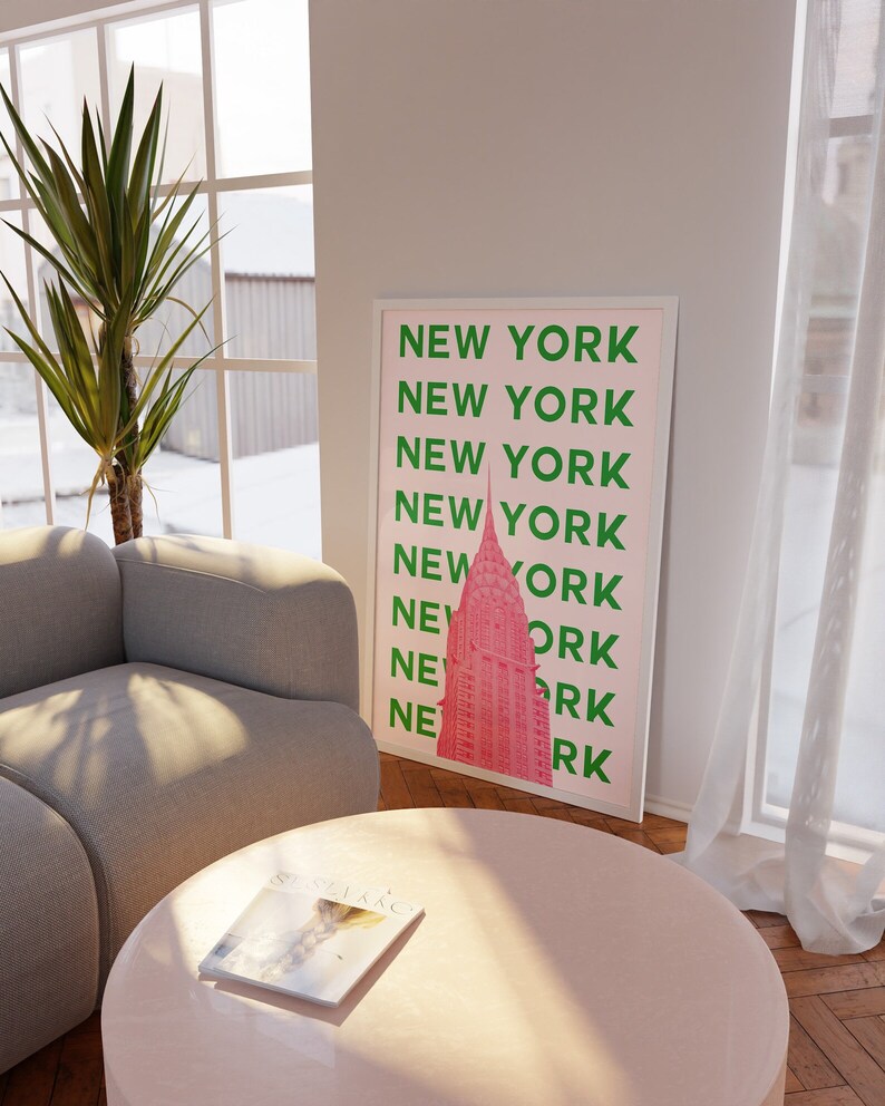 May include: A pink and green poster with the text "NEW YORK" repeated multiple times. The poster features a pink silhouette of the Empire State Building.