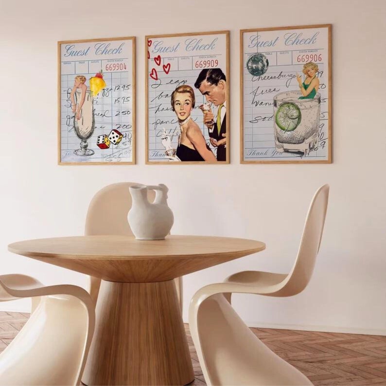 May include: Three framed prints with a vintage aesthetic. Each print features a different illustration of a cocktail with a woman in the background. The first print features a woman in a white dress holding a glass of a pink drink with a cherry on top. The second print features a woman in a black dress with a man in a suit. The third print features a woman in a white dress holding a glass of a green drink with a lime wedge. The text on the prints reads "Guest Check" and includes a number.