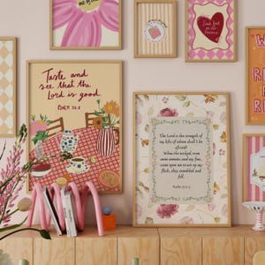 May include: A selection of framed art prints with floral and scripture themes. The prints feature various designs, including a pink flower, a heart, and a table setting with text that reads "Taste and see that the Lord is good."