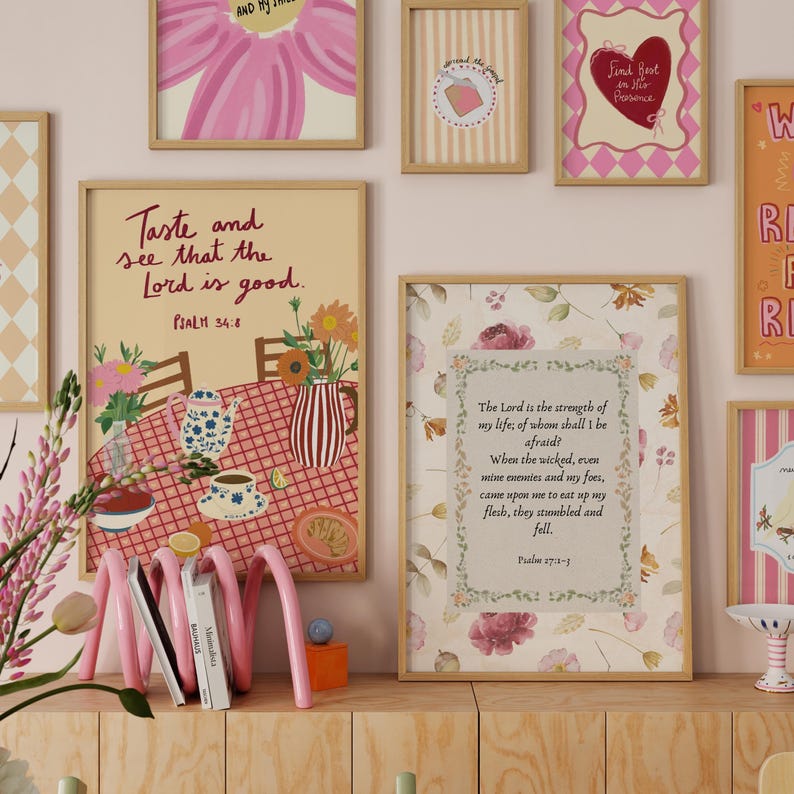 May include: A selection of framed art prints with floral and scripture themes. The prints feature various designs, including a pink flower, a heart, and a table setting with text that reads "Taste and see that the Lord is good."