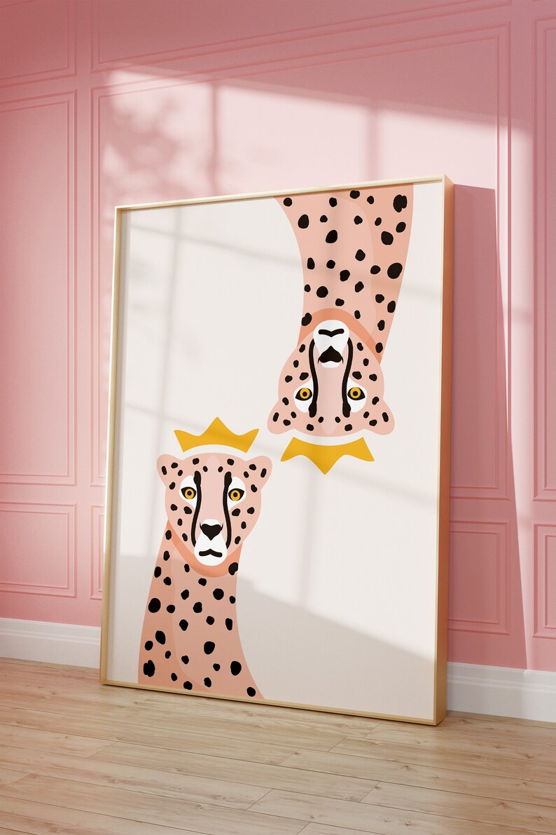 May include: A framed illustration of two pink cheetahs with black spots. The cheetah on the top is upside down and both cheetahs are wearing gold crowns.