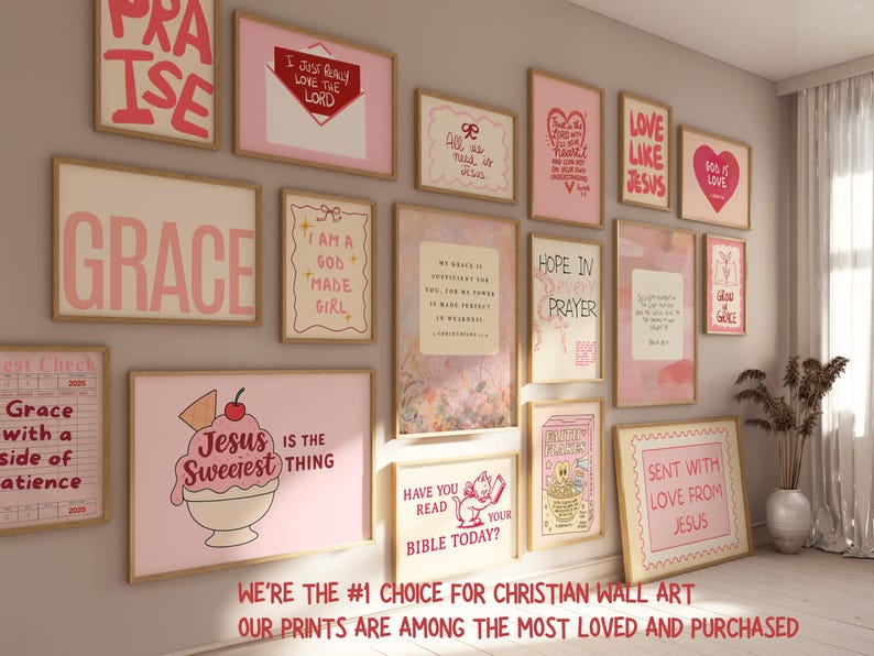 May include: A collection of framed Christian wall art with inspirational quotes and phrases in pink and white. The art includes the words "Praise," "Grace," "Love Like Jesus," and "Jesus is the Sweetest Thing." The frames are displayed on a light-colored wall.