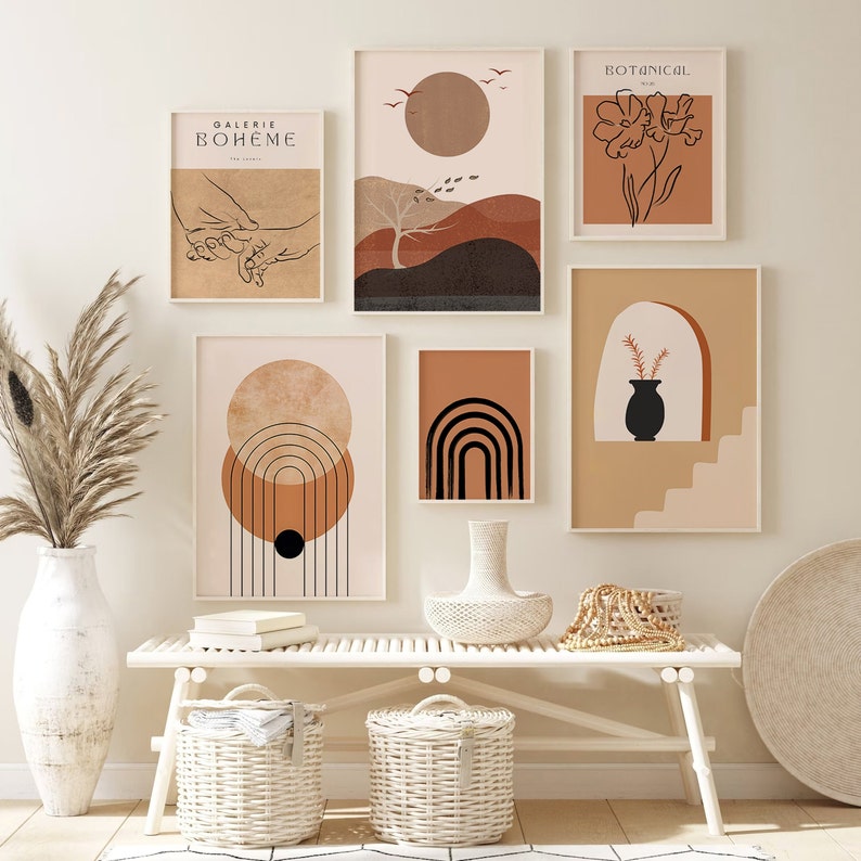 May include: A set of six minimalist art prints with a boho theme. The prints feature abstract shapes, a flower, and a hand holding another hand. The prints are framed in white and have a light brown background.