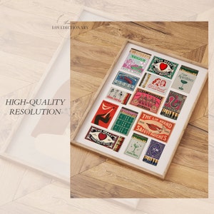 May include: A framed collection of vintage matchbox labels with various designs, including a heart, a lobster, a bicycle, and a martini glass. The labels are in a variety of colors, including red, green, blue, and yellow.