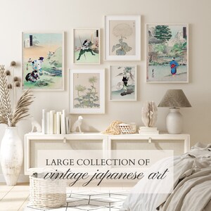May include: A collection of six framed vintage Japanese art prints, featuring scenes of nature, people, and flowers. The prints are displayed on a white wall above a white dresser with a white lamp on the right side. The dresser is decorated with a white vase with dried flowers, a white basket, and two white ceramic animal figurines.