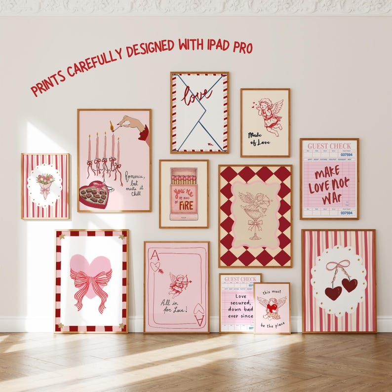 May include: A collection of framed art prints with a Valentine's Day theme. The prints feature illustrations of hearts, cherubs, and romantic phrases in red and pink hues. The text "PRINTS CAREFULLY DESIGNED WITH IPAD PRO" is at the top.