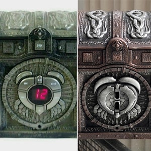 May include: A weathered, metal treasure chest with a combination lock and a digital display showing the number 12. The chest has a silver-coloured metal design with a skull and crossbones motif. The chest is open and the inside is empty.