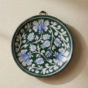 May include: A white ceramic mug with a black handle and the text "But First, Coffee" in a black, bold font. The mug is on a wooden surface.