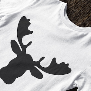 May include: A white t-shirt with a black silhouette of a moose head with antlers.