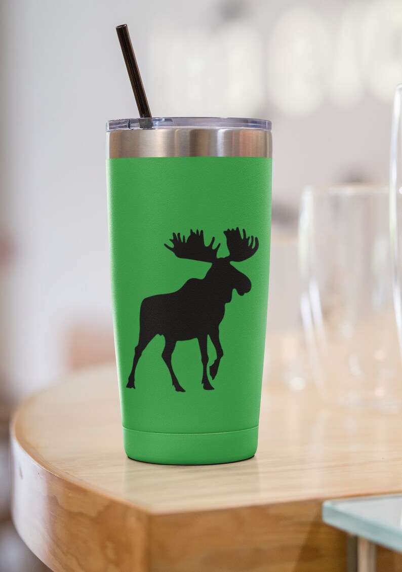 May include: A green stainless steel tumbler with a black moose silhouette design. The tumbler has a lid and a black straw.