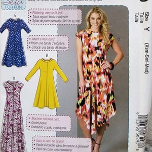 May include: McCall's sewing pattern for beginner dressmaking. The pattern features multiple dress designs, including a blue polka-dot dress, a yellow dress, and a colorful abstract print dress. The pattern includes instructions for easy sewing.