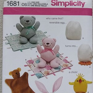 May include: A Simplicity sewing pattern for making a reversible egg that turns into a chick, a brown bear, a pink bear, and a white bunny. The pattern includes instructions for making each toy and a small quilt.