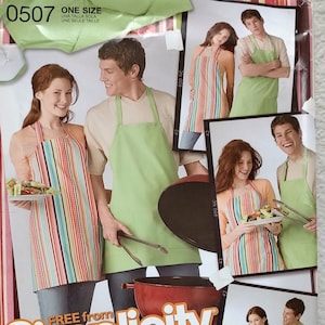May include: A Simplicity sewing pattern for a striped and solid green apron. The pattern is for one size and includes simplified instructions for beginners. The pattern is shown on a model wearing the apron while grilling.