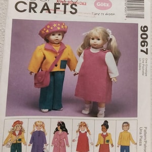 May include: McCall's Crafts sewing pattern 9067 featuring two dolls dressed in handmade outfits. The pattern includes instructions for making various doll clothes, with illustrations of different styles. The text "Götz" and "Time to dream" are also visible.