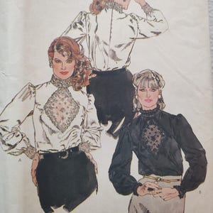 May include: Image of a vintage sewing pattern featuring three women modeling blouses. The blouses have high, lace-trimmed collars, long sleeves, and decorative lace panels. One blouse is black, and two are white.