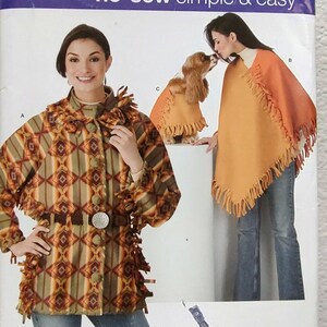 May include: Simplicity sewing pattern 0636, featuring a no-sew design. The pattern includes instructions for a fringed poncho, a fringed jacket, and a matching dog coat. The jacket has a geometric pattern in shades of brown, orange, and green.