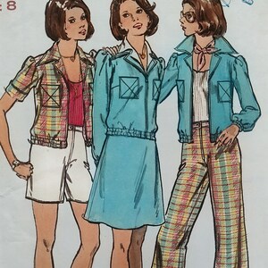 May include: A sewing pattern illustration featuring three outfits: a plaid short-sleeve jacket with white shorts, a solid turquoise zip-up jacket with a matching skirt, and a turquoise zip-up jacket paired with plaid wide-leg trousers.