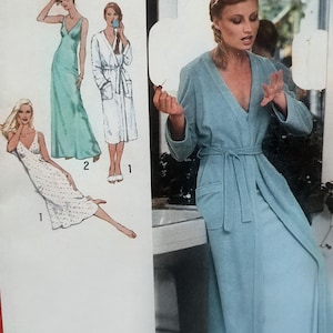 May include: A sewing pattern illustration featuring a long light green slip dress, a white robe with a tie waist, and a white patterned slip dress. A photograph shows a light blue robe with long sleeves, a V-neckline, and a matching tie belt.