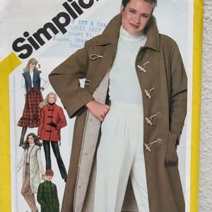 May include: A Simplicity sewing pattern envelope featuring a brown toggle coat with a light-colored sherpa lining. The cover displays illustrations of various garments including a plaid skirt, a red jacket, a long vest, and a green coat.