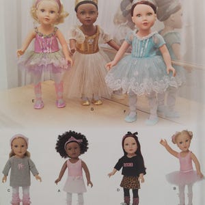 May include: A collection of dolls dressed in various ballet and dance outfits. The dolls feature different skin tones and hairstyles, wearing tutus, leotards, and crowns. Some dolls are in pink, blue, and gold outfits, while others wear casual attire with the word "DANCE" on a shirt.