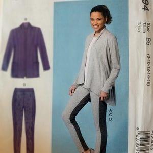 May include: McCall's sewing pattern M7294 featuring a woman wearing a gray cardigan and leggings with a black stripe down the side. The pattern also shows a purple jacket and leggings. The size range is B5 (8-10-12-14-16).