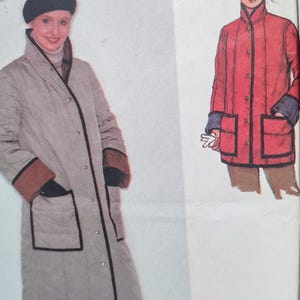May include: A sewing pattern illustration featuring a long, light gray quilted coat with a high collar, dark brown cuffs, and black trim along the front opening and pockets. Beside it, a shorter red quilted jacket with black trim and cuffs.