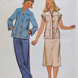 May include: A sewing pattern envelope featuring illustrations of two outfits. One outfit includes a blue long-sleeved jacket with a mandarin collar and matching trousers. The second outfit features a beige sleeveless vest with a mandarin collar and a skirt.