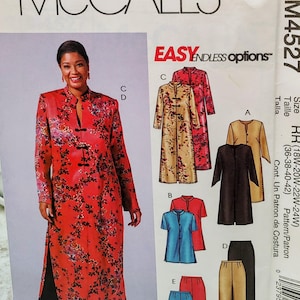 May include: McCall's M4527 sewing pattern envelope featuring a red floral tunic with a mandarin collar and black frog closures, paired with black trousers. The envelope displays illustrations of various tunic and pant options in sizes 18W-24W.