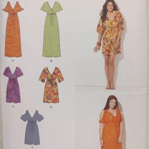 May include: Simplicity pattern 1375 features easy-to-sew wrap dresses in various styles. The pattern includes options for different sleeve lengths and dress lengths. The image shows the dress designs in orange, green, purple, and floral prints.