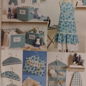 May include: A collection of laundry and cleaning accessories, including a blue floral apron, storage bins, hangers, and a hanging organizer. The items are in shades of blue and white, with a vintage aesthetic.