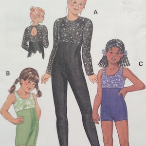 May include: An illustration of three different leotard designs. One is a black jumpsuit with a starry top. The second is a green leotard with a white floral design. The third is a purple leotard with a blue floral design.