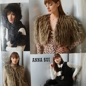 May include: Vogue Accessories sewing pattern V639 by Anna Sui featuring various faux fur garments. The envelope displays images of a brown faux fur bolero, a brown faux fur vest, a black faux fur hood and scarf set, and black faux fur leg warmers.