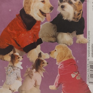 May include: A sewing pattern envelope featuring five dogs wearing various garments: a red jacket with black trim, a light gray floral top with blue flowers, a light pink top with a back bow, a black hooded jacket, and a pink hooded sweatshirt.