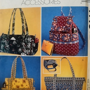 May include: Image of a McCall's Fashion Accessories pattern featuring various bag designs. The bags include a black floral tote, a red paisley backpack, a yellow floral tote, and a blue patterned tote. The pattern includes the text "MCCALL'S FASHION ACCESSORIES".