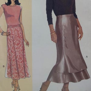 May include: Two illustrations of women's skirts. One skirt is a long, A-line style with a pink top and a red floral print skirt. The other skirt is a long, satin-like skirt with a layered, flared hem. The skirt is a muted, dusty rose color.
