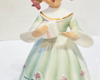 Figura vintage de porcelana Schmidt Bros. de la década de 1960 con caja de música funcional: niña sosteniendo un regalo. Japón.