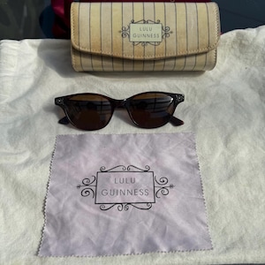 Okulary przeciwsłoneczne Lulu Guinness vintage w kolorze skorupy żółwia, klasyczny styl kocich oczu, metalowa zdobiona oprawka, oryginalne kremowe twarde etui i ściereczka do czyszczenia.