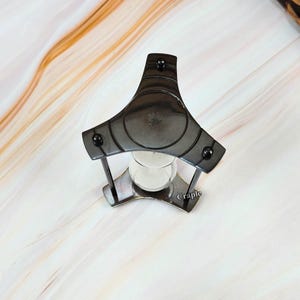 May include: A set of three ceramic mugs with a speckled, matte finish. The mugs are in shades of cream, light gray, and dark gray. Each mug has a simple, minimalist design, perfect for coffee or tea.