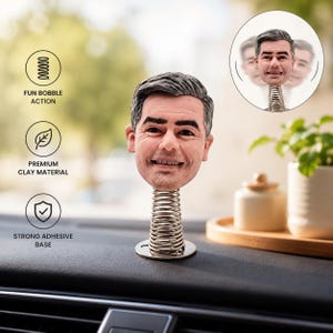 May include: A custom bobblehead figure featuring a realistic sculpted head with grey hair mounted on a silver metal spring base. The figure includes a circular adhesive base for mounting. Text on the image highlights fun bobble action, premium clay material, and a strong adhesive base.