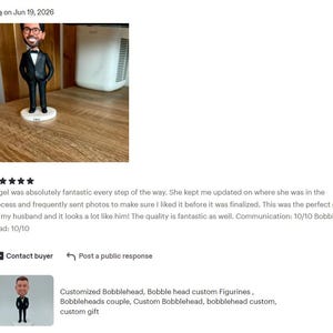 May include: A custom bobblehead figurine featuring a person with brown hair and glasses, wearing a black tuxedo with a white shirt and a black bow tie. The figure stands on a round white base and is depicted with hands resting on the hips.