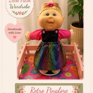 May include: A doll with blonde hair tied with a pink bow, wearing a bright pink long-sleeve shirt under a black pinafore dress with a metallic rainbow chequered skirt. The image includes text reading Little Patch Wardrobe, Handmade with Love, and Retro Pinafore OUTFIT.