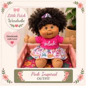 May include: A doll with dark curly hair styled with a patterned scrunchie, wearing a bright pink t-shirt with the text p!nk and a matching skirt featuring a colourful graphic print. The doll is seated in a small pink wooden frame with a floral base.