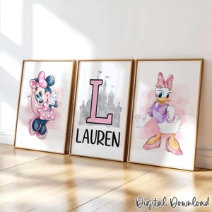 May include: Three framed prints featuring Disney characters Minnie Mouse and Daisy Duck, and a personalized print with the name "Lauren". The prints have a watercolor style with pink accents and are set against a white background.