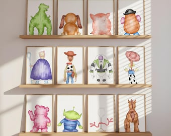 May include: Twelve framed watercolor prints displayed on three wooden shelves, featuring the back views of various animated characters including a green dinosaur, a brown dog, a pink pig, a potato figure, a shepherd, a cowboy, a space ranger, and a cowgirl.